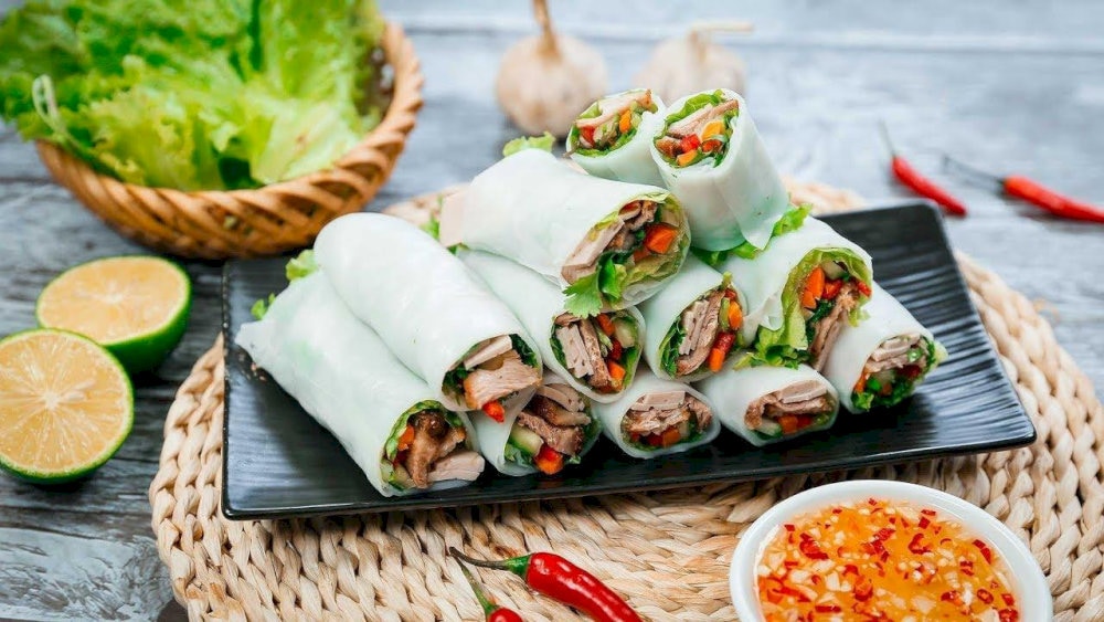 Delightful pho cuon with savory beef, fresh herbs, and a hint of dipping sauce